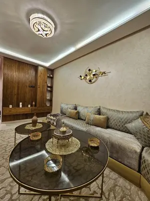 a living room with two tables and a couch at Hay mabroka in Oulad Akkou