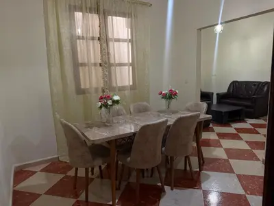 a dining room table with chairs and flowers on it at Residence meknes in Meknès