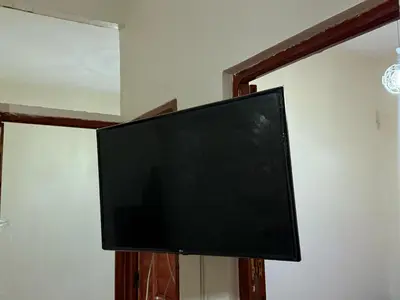 a flat screen tv hanging on a wall at Residence meknes in Meknès