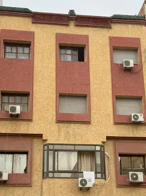 a building with three windows and two speakers at Residence meknes in Meknès