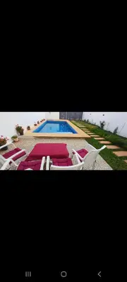 two pictures of a pool with chairs and a swimming pool at Villa de luxe in Imouzzer Kandar