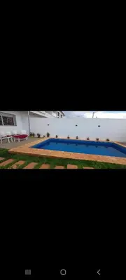 a large blue swimming pool in a building at Villa de luxe in Imouzzer Kandar