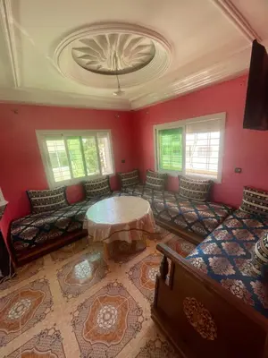 a living room with a couch and a table at منزل العمراني in Oulad Akkou