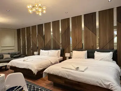 a bedroom with two beds and a chandelier at Suite Bahiya 21 in Fès