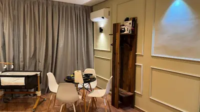 a room with a table and chairs and a window at Suite Bahiya 21 in Fès