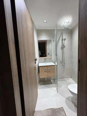 a bathroom with a toilet and a sink and a shower at Suite Bahiya 21 in Fès