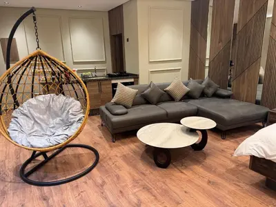 a living room with a couch and a swing at Suite Bahiya 21 in Fès