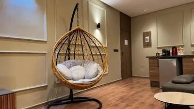 a hanging basket chair in a living room at Suite Bahiya 21 in Fès