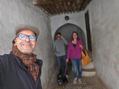 three people standing in a tunnel with a dog at Appartement familial شقة للعائلة in Meknès
