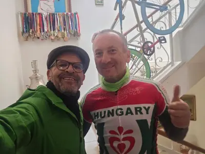 two men giving a thumbs up next to a bike at Appartement familial شقة للعائلة in Meknès
