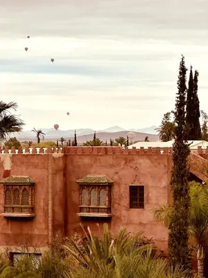 an old building with two windows and hot air balloons at Villa Dar Ambre in Marrakech