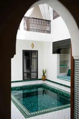 a swimming pool in a villa with a house at Villa Dar Ambre in Marrakech
