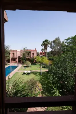 a view of a yard with a pool and a house at Villa Dar Ambre in Marrakech