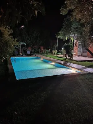 a swimming pool at night with lights on it at Charming Villa with Pool in Amekhlig