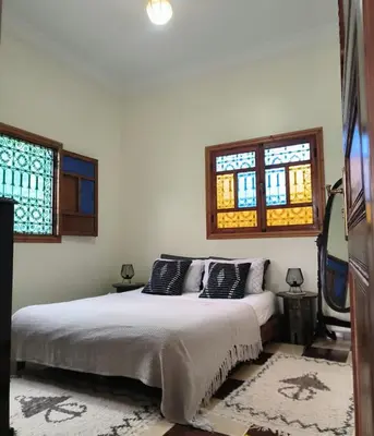 a bedroom with a bed and two windows at Charming Villa with Pool in Amekhlig