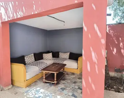 a living room with a couch and a table at Charming Villa with Pool in Amekhlig