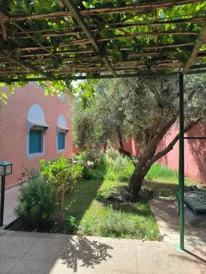 a garden with a tree and a building at Charming Villa with Pool in Amekhlig