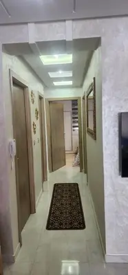 a hallway in a building with a rug on the floor at مفتاح الساحل انزا in Oulad Akkou