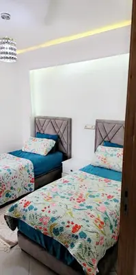 a bedroom with two beds in a room at مفتاح الساحل انزا in Oulad Akkou