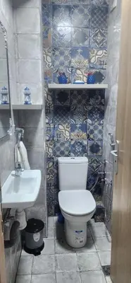 a bathroom with a toilet and a sink at مفتاح الساحل انزا in Oulad Akkou