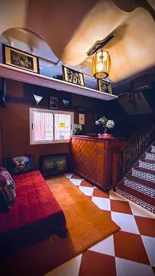 a room with a staircase and a red and white floor at Raid rooftop atlas dades in Boumalne