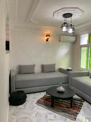 a living room with a couch and a table at Appartement bel kayed in Fès