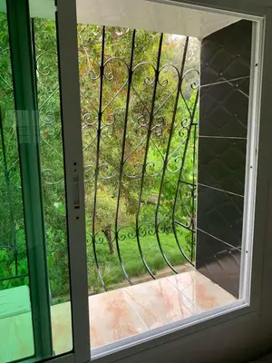 a glass door with a view of a yard at Appartement bel kayed in Fès