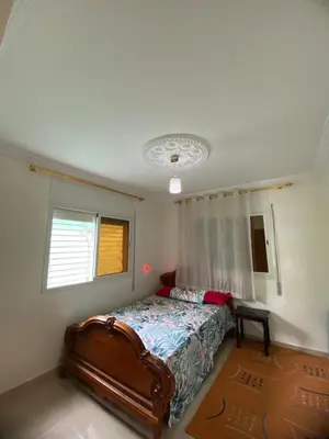 a bedroom with a bed and a window at Ferme Arougo in Oulad Akkou