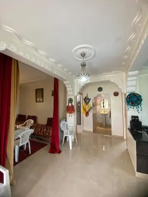 a living room with a couch and a table at Ferme Arougo in Oulad Akkou