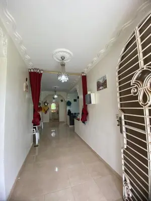a hallway with red drapes on the walls at Ferme Arougo in Oulad Akkou