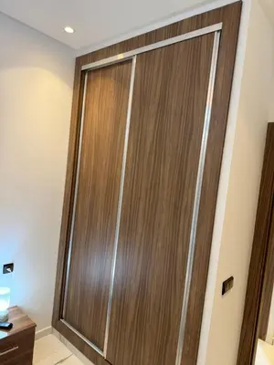 a wooden sliding door in a bathroom at Mehdia plage apparemment in Oulad Akkou