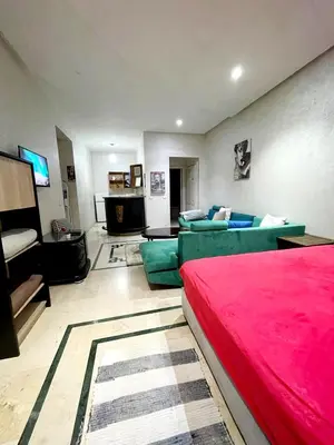 a living room with a red bed and a couch at اقامة فال دانفا in Oulad Akkou