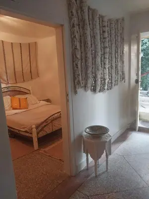 a bedroom with a bed and a table in a room at Gite Montana in Aïn Leuh