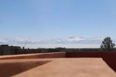 a view of the mountains from the roof of a building at Villa Yassin Private Pool and Terrace in Marrakech