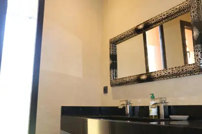 a bathroom with a black sink and a mirror at Villa Yassin Private Pool and Terrace in Marrakech