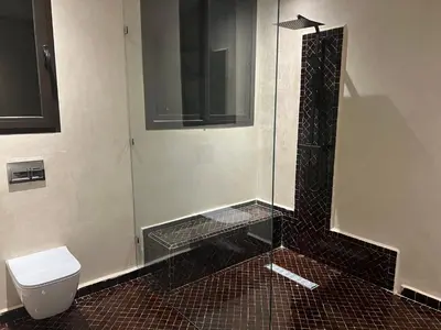 a bathroom with a glass shower with a toilet at Villa Yassin Private Pool and Terrace in Marrakech