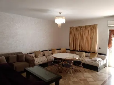 a living room with a couch and a table at فيلا بالصخيرات in Oulad Akkou
