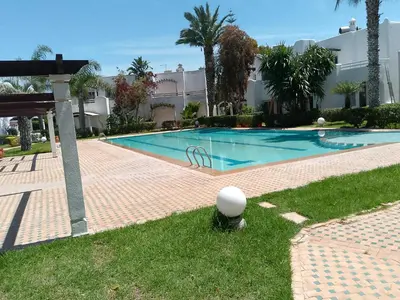 a swimming pool in the middle of a yard at فيلا بالصخيرات in Oulad Akkou