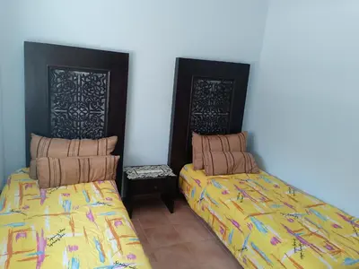 two beds sitting next to each other in a room at فيلا بالصخيرات in Oulad Akkou