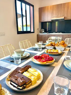 a table with many plates of food on it at Villa Elysia in Chaibate
