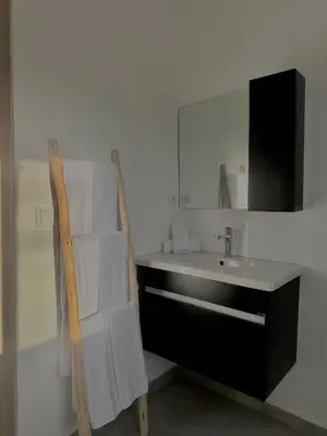 a bathroom with a sink and a mirror at Villa Elysia in Chaibate