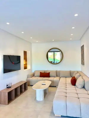 a living room with a couch and a table at Villa Elysia in Chaibate