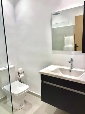 a bathroom with a sink and a toilet and a mirror at Villa Elysia in Chaibate