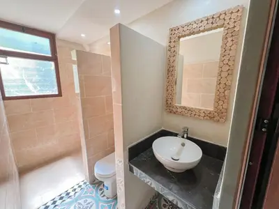 a bathroom with a sink and a mirror at Tabourihte Gardens in Tinerhir