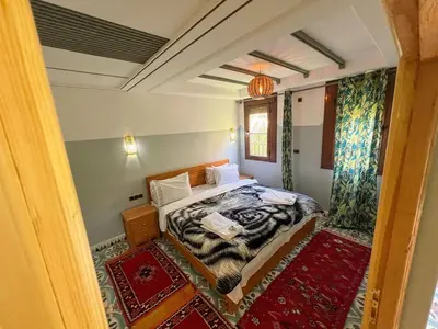 a small bedroom with a bed and a window at Tabourihte Gardens in Tinerhir