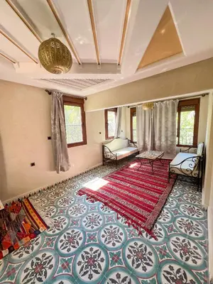 a large room with a large rug on the floor at Tabourihte Gardens in Tinerhir
