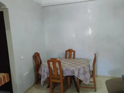 a dining room with a table and chairs at Le jardaine d'Ifrane in Oulad Akkou