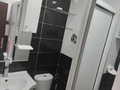 a bathroom with a toilet and a sink and a shower at Le jardaine d'Ifrane in Oulad Akkou