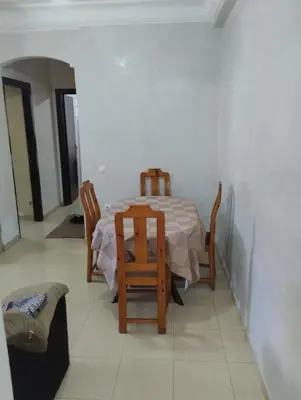 a dining room with a table and chairs in a room at Le jardaine d'Ifrane in Oulad Akkou