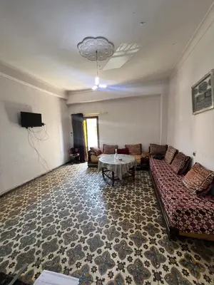 a living room with a couch and a table at Appartement 135 m spacieux in Oulad Akkou